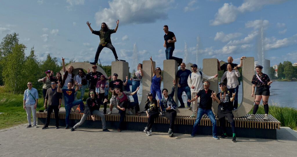 group of people posing with air guitars in a park